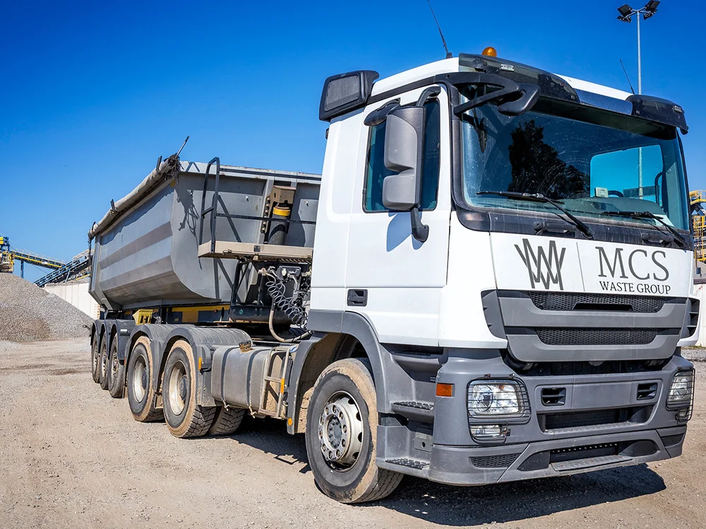 Tipper grab lorry removing bulk materials